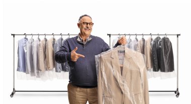 Mature man holding suit at dry cleaners and pointing isolated on a white backgroun clipart