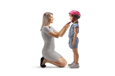 Mother putting on a helmet at a daughters head isolated on white background