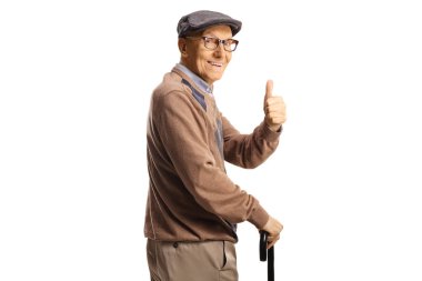 Happy senior man with a cane looking over shoulder and gesturing thumbs up isolated on white background