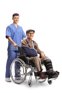 Male nurse and an injured mature patient in a wheelchair isolated on white background 