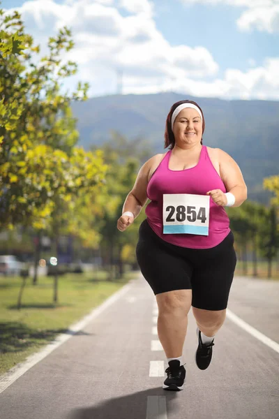 Overweight woman running a marathon in a city