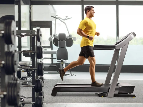 Full Length Profile Shot Young Man Running Treadmill Gym — Stock Photo, Image