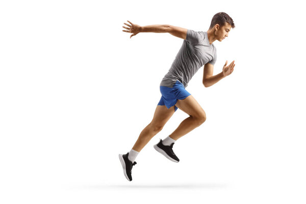 Full length profile shot of a fit guy running isolated on white background