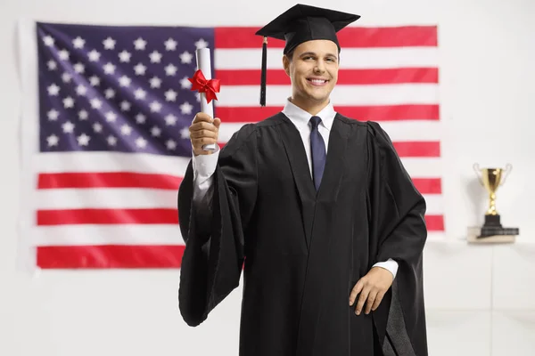 Young Man Graduation Gown Cap Holding Diploma Front Usa Flag — Stock Photo, Image