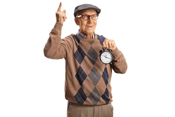 Elderly Man Holding Alarm Clock Pointing Isolated White Background — Stock Photo, Image