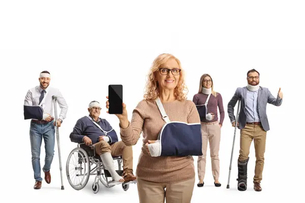 Female patient with a smartphone and a group of people with crutches and a wheelchair, trauma and injury isolated on white background