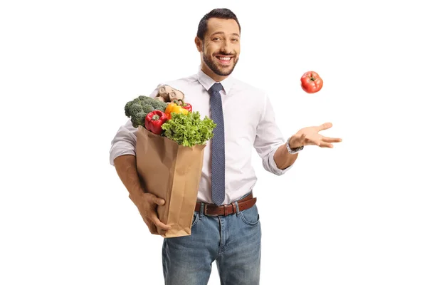 Cheerful Young Professional Man Holding Grocery Bag Juggling Tomato Isolated — Stock Photo, Image