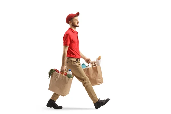 Full Length Profile Shot Delivery Guy Carrying Bags Groceries Walking — Stock Photo, Image