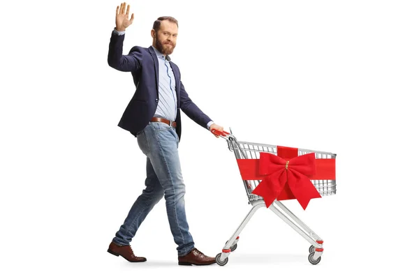 Bärtiger Mann Winkt Und Schiebt Und Leert Einkaufswagen Mit Roter — Stockfoto