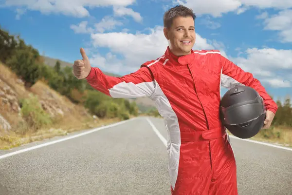 Racer Red Suit Holding Helmet Hitchhiking Open Road — Stock Photo, Image