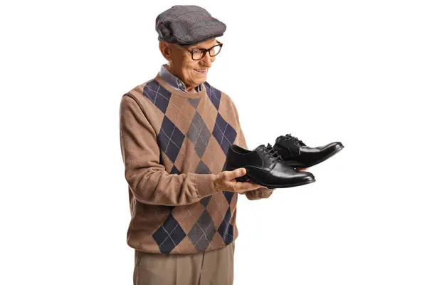 Älterer Mann Hält Ein Paar Schwarze Lederschuhe Und Lächelt Isoliert — Stockfoto