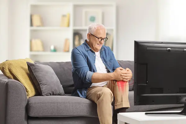 Mature Man Pain Sitting Sofa Front Holding His Red Inflamed — Stock Photo, Image