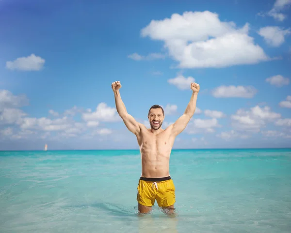 Young Man Yellow Swimming Shorts Standing Ocean Gesturing Happiness — Stock Photo, Image