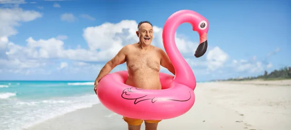 Lycklig Mogen Man Med Stor Uppblåsbar Flamingo Gummiring Poserar Strand — Stockfoto