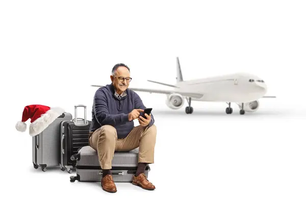 Mature Man Booking Christmas Flight Sitting Suitcase Isolated White Background — Stock Photo, Image