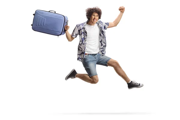 stock image Happy male traveler jumping with a suitcase isolated on white background