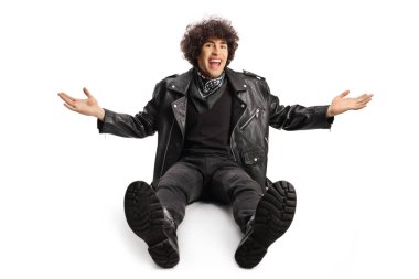 Young man in a leather jacket lauging and sitting on the ground  isolated on white background