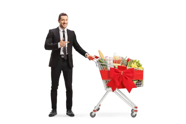 Full Length Portrait Businessman Shopping Cart Full Food Pointing Isolated — Photo