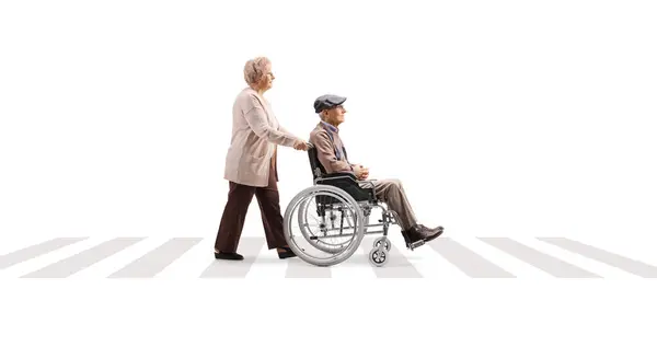 Full Length Profile Shot Elderly Woman Pushing Elderly Man Wheelchair — Stockfoto