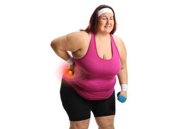 Plus size woman in sportswear with a stiff back holding a dumbbell isolated on white background