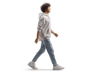 Full length portrait of a tall guy with curly hair walking isolated on white background