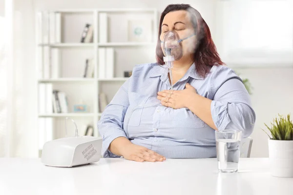 Corpulent Young Woman Holding Her Chest Using Nebulizer Home — Stok fotoğraf