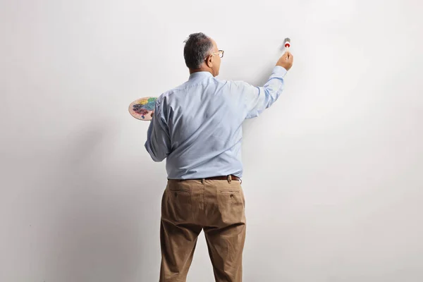 Olgun Bir Adamın Duvarın Önünde Fırça Palet Tutarken Çekilmiş Dikiz — Stok fotoğraf