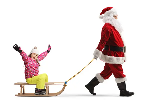Papai Noel Puxando Trenó Madeira Com Uma Menina Pequena Feliz — Fotografia de Stock