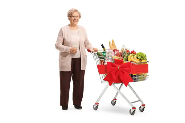 Elderly Woman Posing Shopping Cart Tied Red Ribbon Full Food — Stock Photo, Image