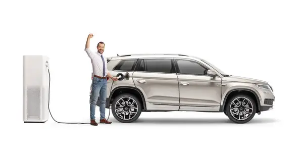 Businessman Charging Suv Electric Vehicle Station Gesturing Victory Isolated White — Stock Photo, Image