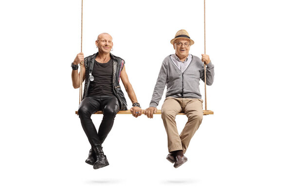 Punk and senior man sitting together on a wooden swing isolated on white background