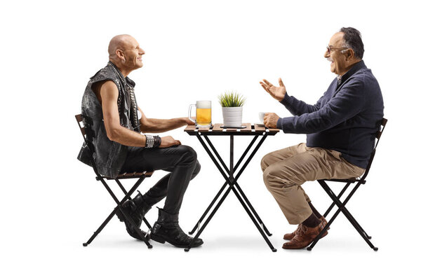 Punk with a pint of beer at a cafe and a mature man with a cup of coffee having a conversation isolated on white background