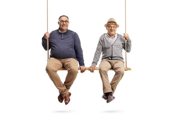 Elderly male friends sitting on a big wooden swing isolated on white background