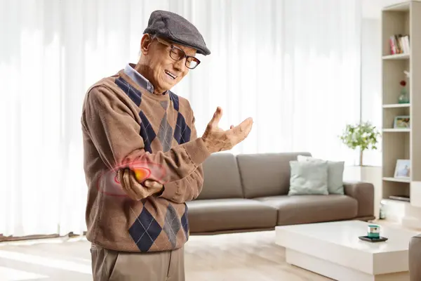 Elderly Man Pain Holding Elbow Home Living Room — Stock Photo, Image