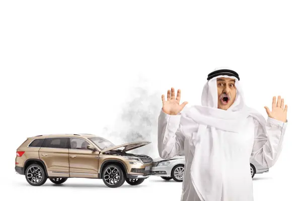 Schockierter Araber Vor Unfallfahrzeugen Auf Weißem Hintergrund Stockbild