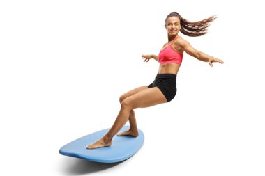 Beyaz arka planda izole bir sörf tahtası süren kadın sörfçü.