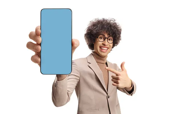 Young Man Curly Hair Holding Mobile Phone Blue Screen Pointing Stockbild