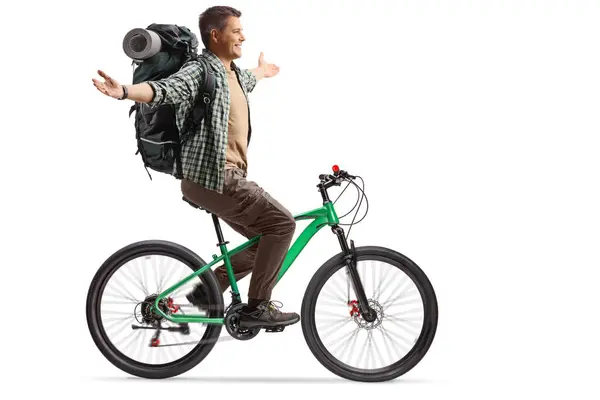 Full Length Profile Shot Young Man Backpack Riding Bicycle Isolated lizenzfreie Stockfotos