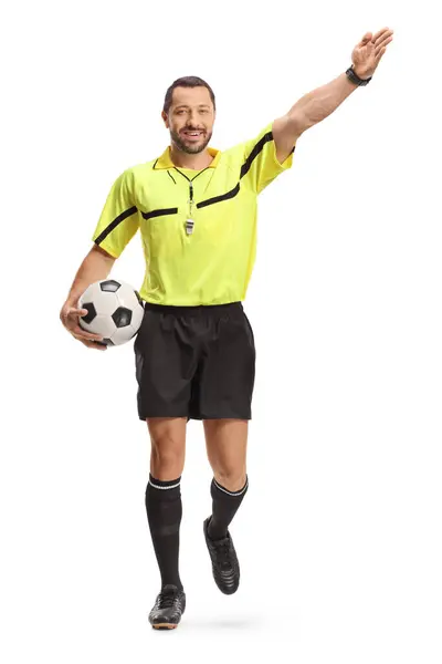 stock image Portrait of a football referee carrying a ball and pointing with hand isolated on white background