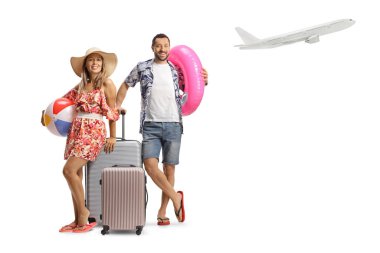 Bir uçağın yanında bavul taşıyan genç turistler beyaz arka planda izole bir şekilde havalanıyorlar.