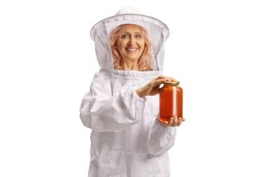 Woman bee keeper holding a honey jar and smiling isolated on white background clipart