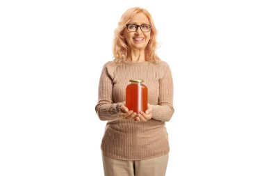 Middle aged woman holding a honey jar isolated on white background clipart