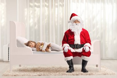 Gilr uyuyor ve Noel Baba bir odada yatağında oturuyor.