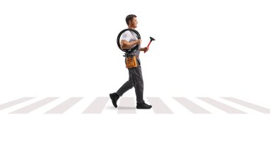 Plumber walking at a pedestrian crossing with a plunger and drain snake isolated on white background clipart