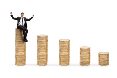 Başarılı bir işadamı, beyaz arka planda izole edilmiş bozuk para yığınını kutluyor.