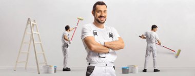 Team of painters working and painting a wall 