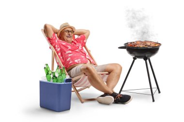 Buzdolabında biraları ve beyaz arka planda izole edilmiş barbeküsü olan mutlu bir adam.