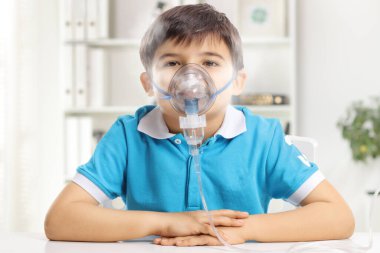 Kid using a nebulizer with mist in a room