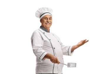 Mature male chef holding a turner isolated on white background