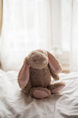 Beautiful plush rabbit on childrens bed. Childrens room. Cosy. Easter.